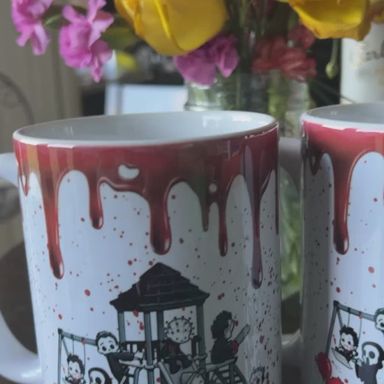 This white ceramic mug comes blood stained with our favorite Halloween villains on the playground.   Material: White ceramic mug  Dimensions: 11 and 15 oz.  Care Instructions: Mug dishwasher and microwave safe.  